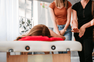 People practice a massage technique in the Massage Workshop for 2 persons